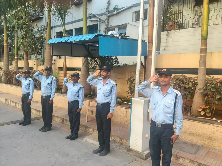 Uniformed OSS security guards saluting at a residential complex